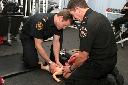 Practicing medical treatment on a mock baby